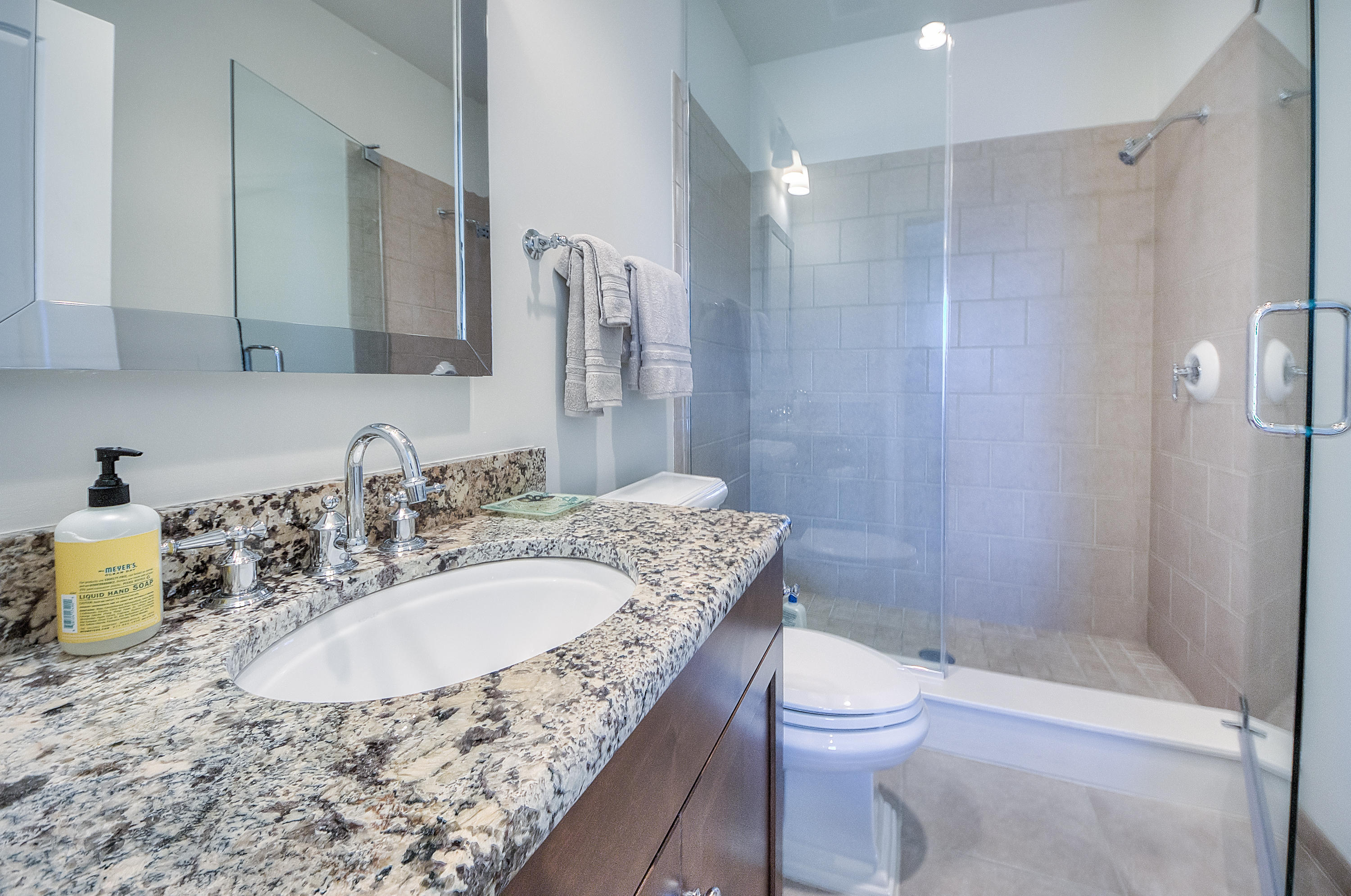 37 Compass Point Way, Unit 104 Watersound, FL 32461 - Photo 19 of 27 a bathroom with a granite countertop sink toilet and shower