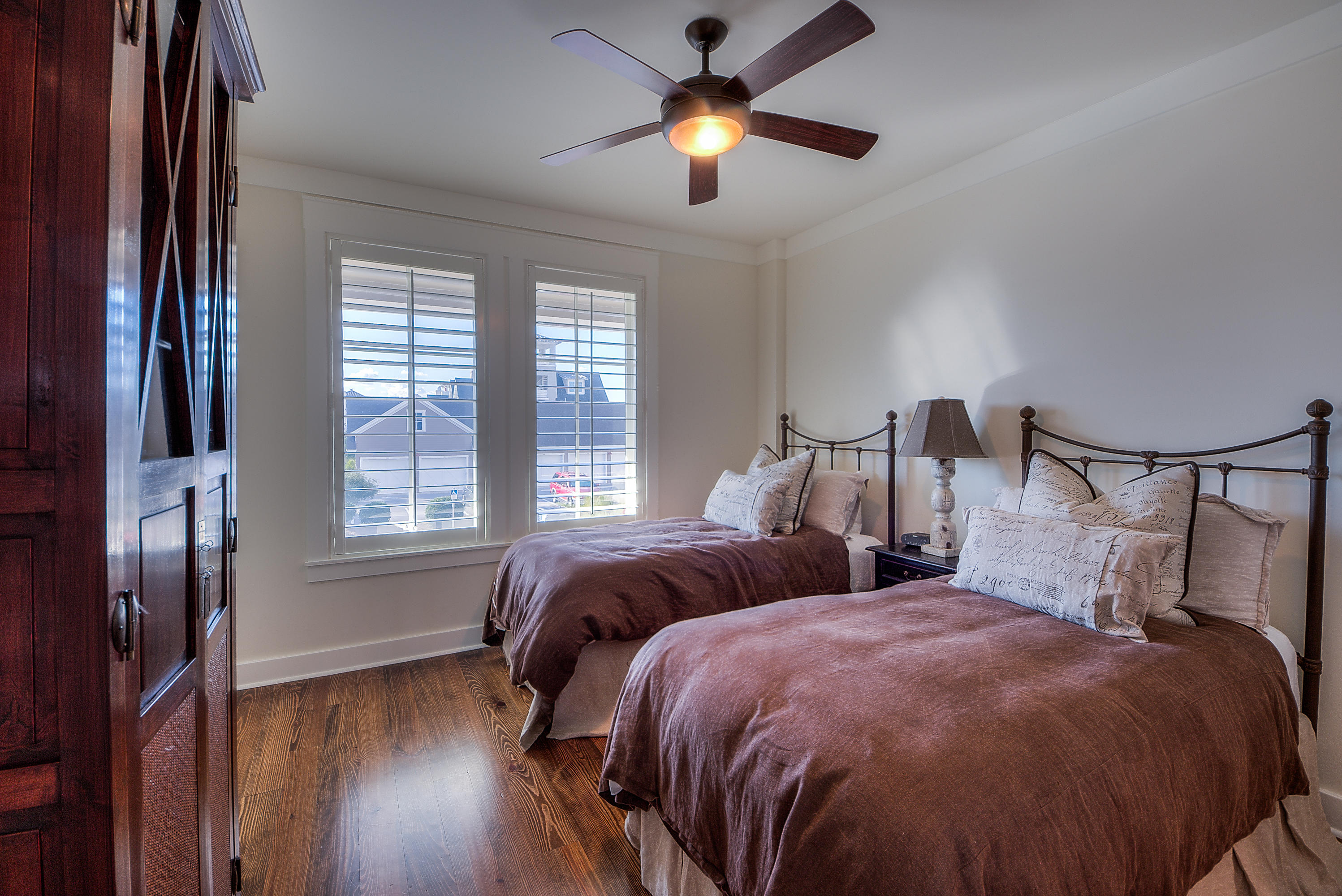 37 Compass Point Way, Unit 104 Watersound, FL 32461 - Photo 20 of 27 a bedroom with two beds and a chandelier