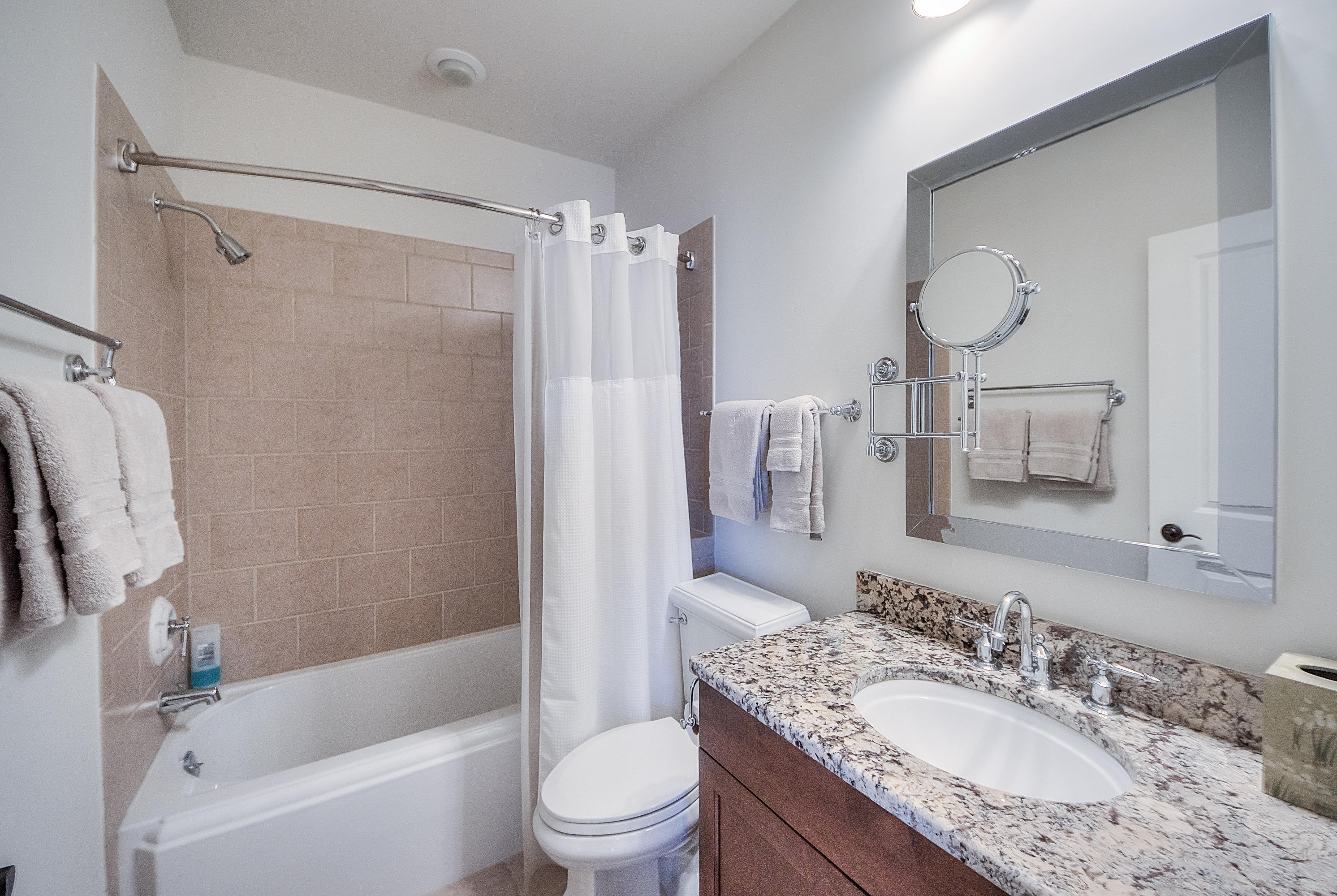 37 Compass Point Way, Unit 104 Watersound, FL 32461 - Photo 21 of 27 a bathroom with a granite countertop sink toilet and shower
