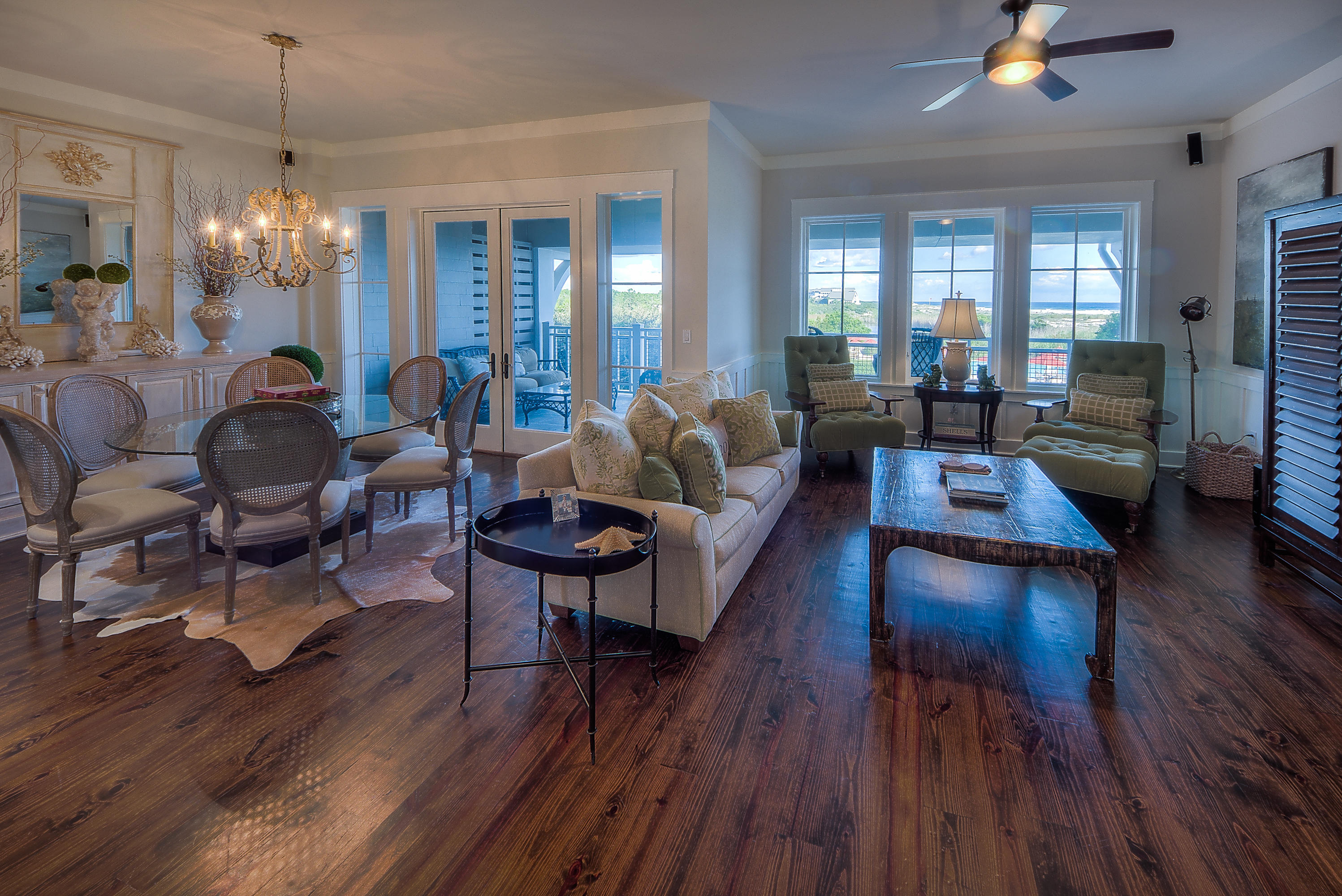 37 Compass Point Way, Unit 104 Watersound, FL 32461 - Photo 4 of 27 a living room with furniture and a chandelier