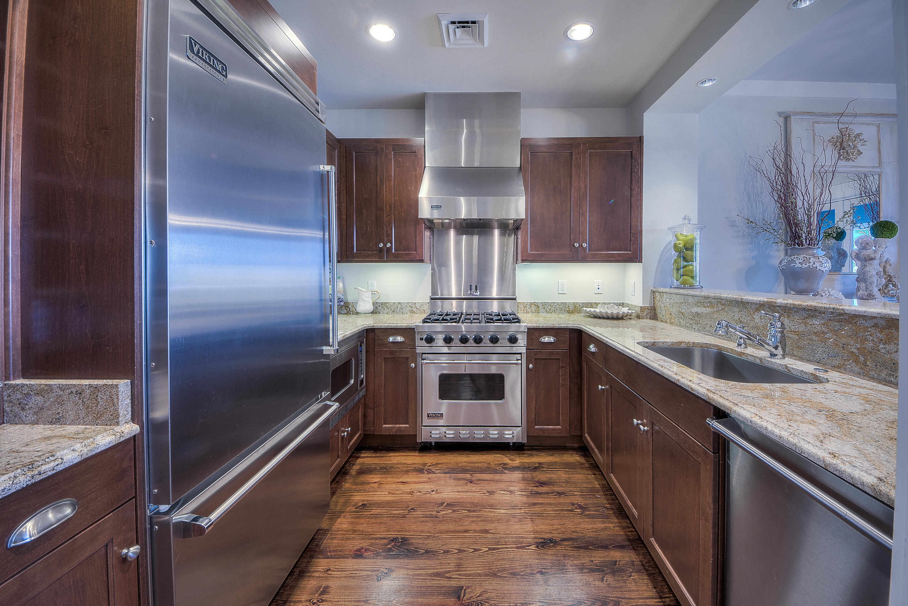 37 Compass Point Way, Unit 104 Watersound, FL 32461 - Photo 8 of 27 a kitchen with stainless steel appliances granite countertop a stove and a refrigerator