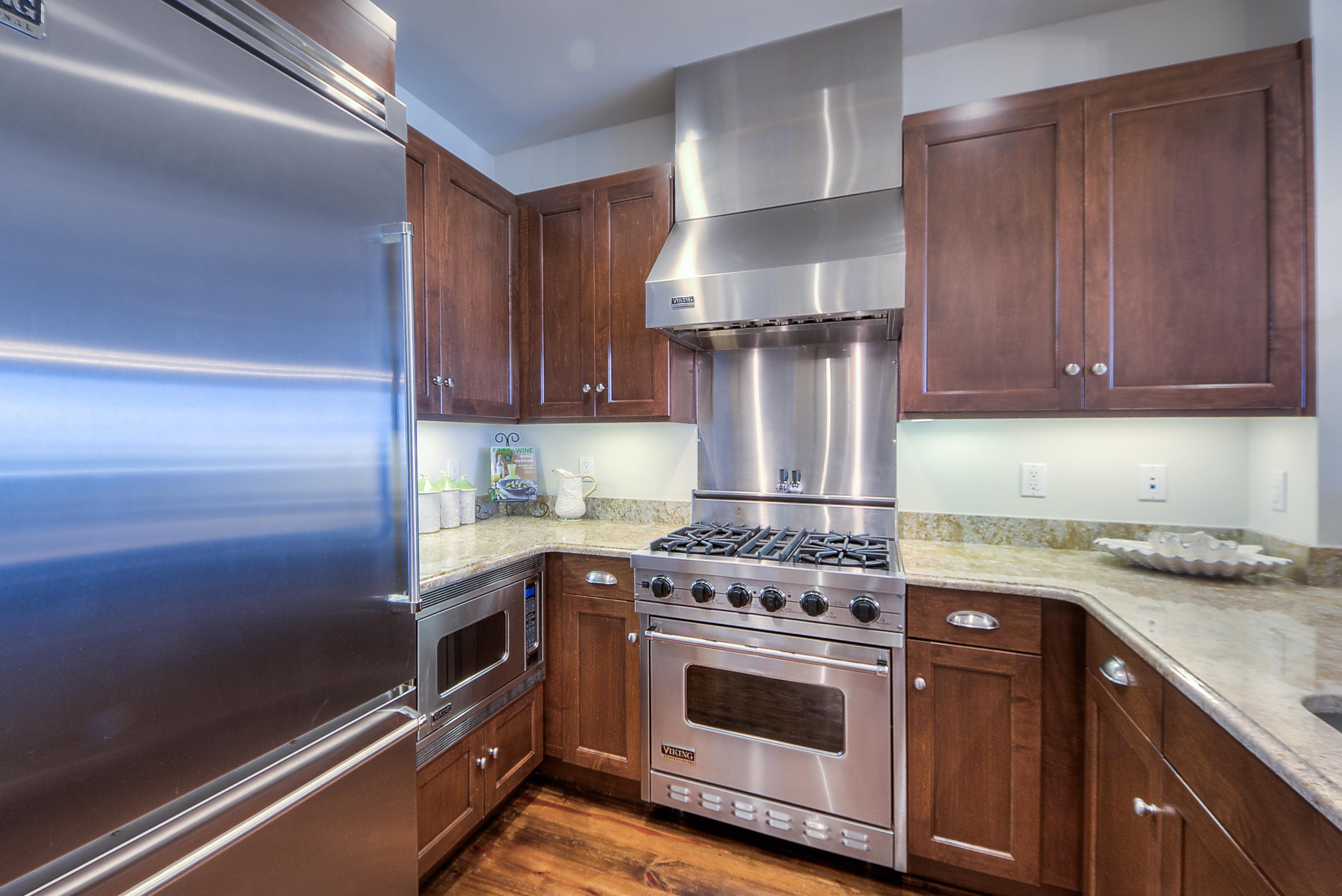 37 Compass Point Way, Unit 104 Watersound, FL 32461 - Photo 9 of 27 a kitchen with stainless steel appliances granite countertop a stove a sink and a refrigerator