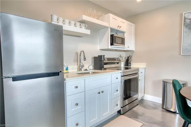 a kitchen with cabinets and appliances