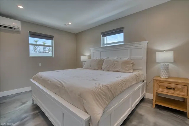 a bedroom with a bed and a night stand