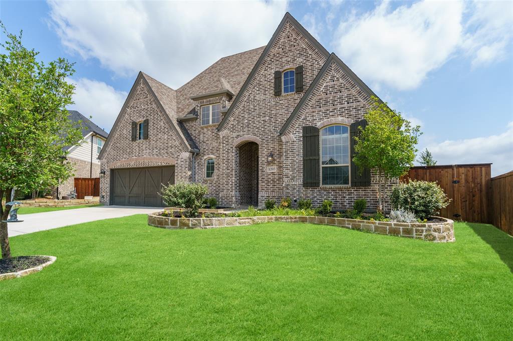 1205 Lake Hills Trail Roanoke, TX 76262 - Photo 1 of 29 a front view of a house with a garden and yard