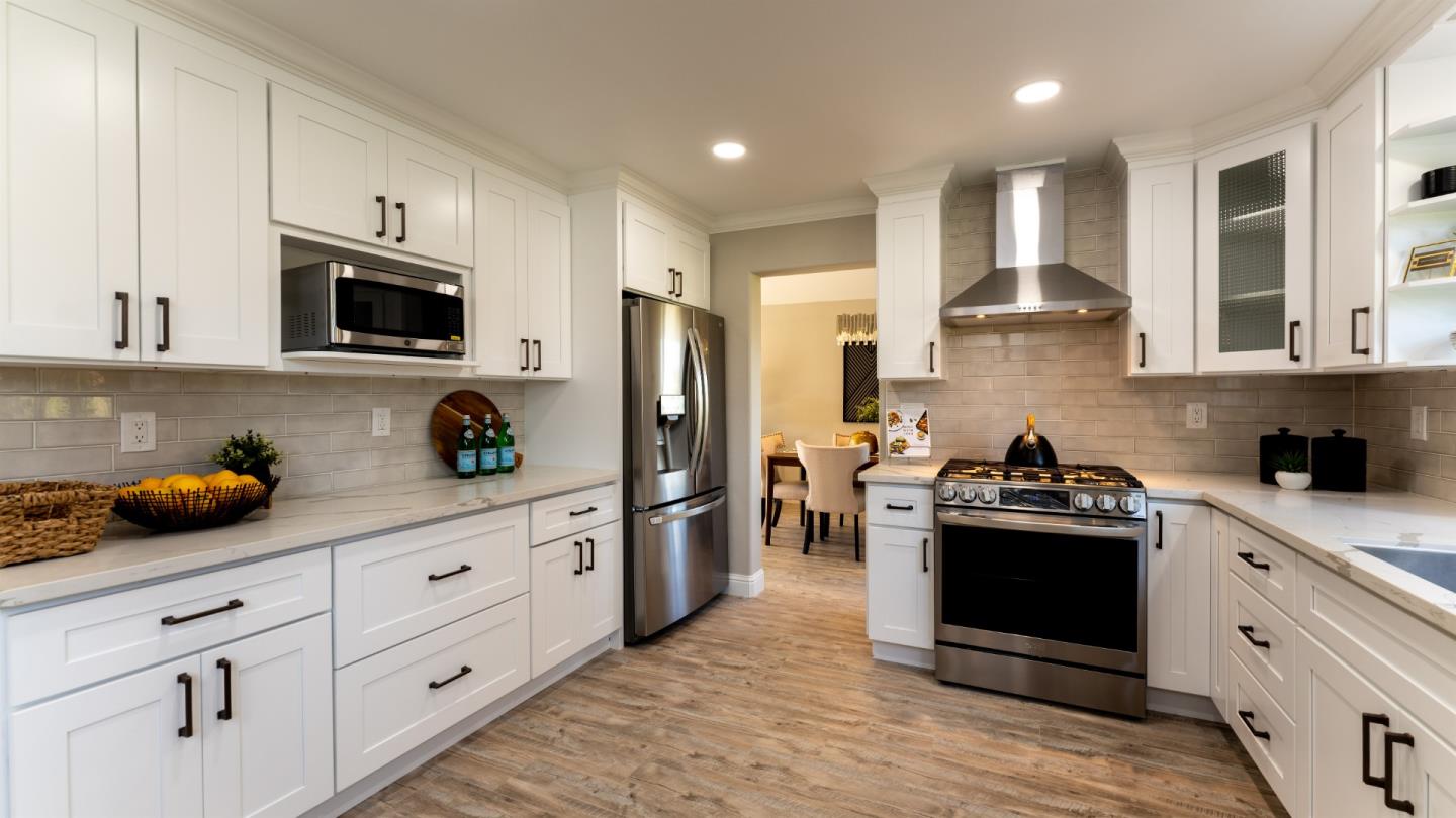 3253 Cheryl Circle Pleasanton, CA 94588 - Photo 10 of 37 a kitchen with stainless steel appliances kitchen island granite countertop a refrigerator and a stove top oven