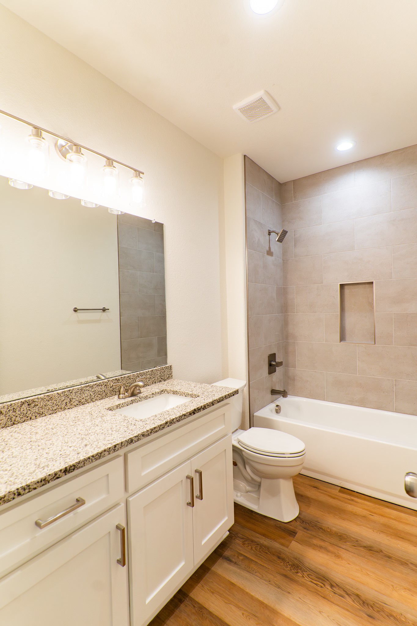 309 String Prairie Way Smithville, TX 78957 - Photo 26 of 30 a bathroom with a granite countertop sink toilet a large mirror a bathtub and shower