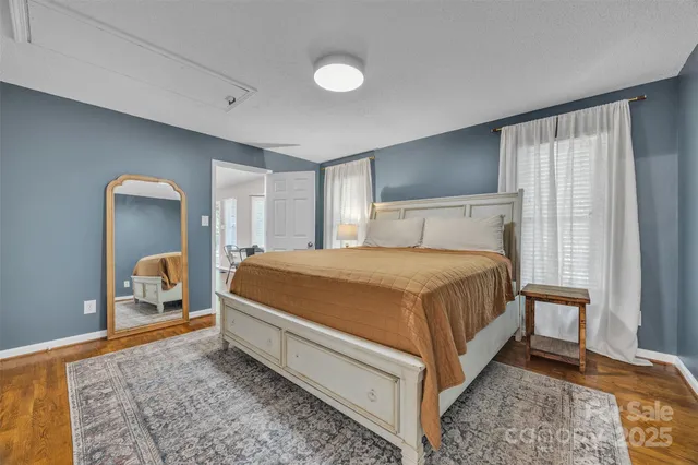 a bed room with a bed and mirror