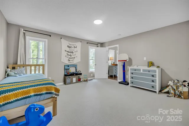 a very nice looking bedroom with a bed and a large window