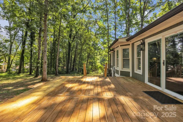 a view of backyard of house with green space