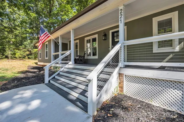 a view of a house with backyard and deck