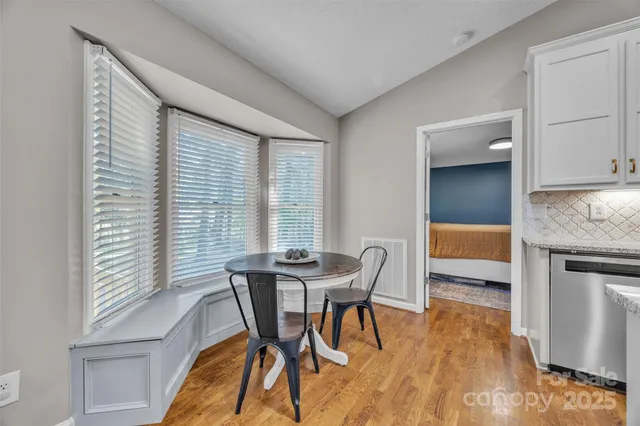 a dining room with furniture and wooden floor