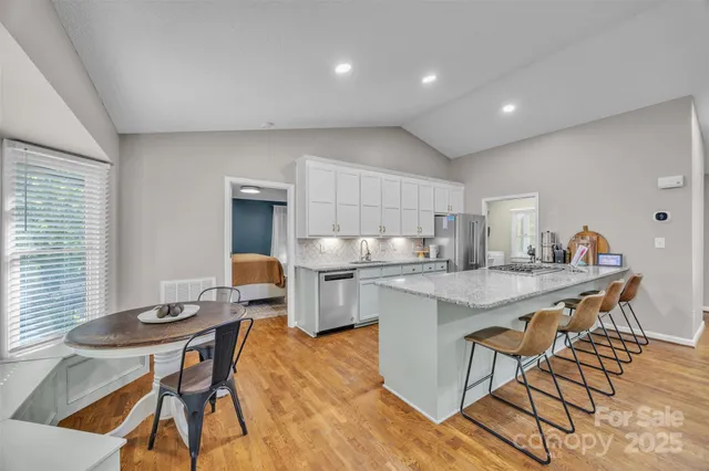 a kitchen with a table chairs and a refrigerator