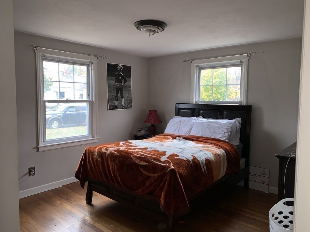 154 Mayflower Road Springfield, MA 01118 - Photo 9 of 15 a bedroom with a bed and wooden floor