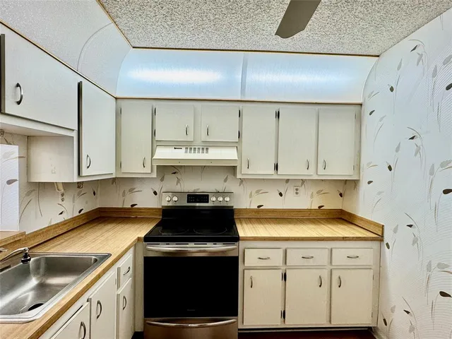 a view of a room with wooden floor table and chairs