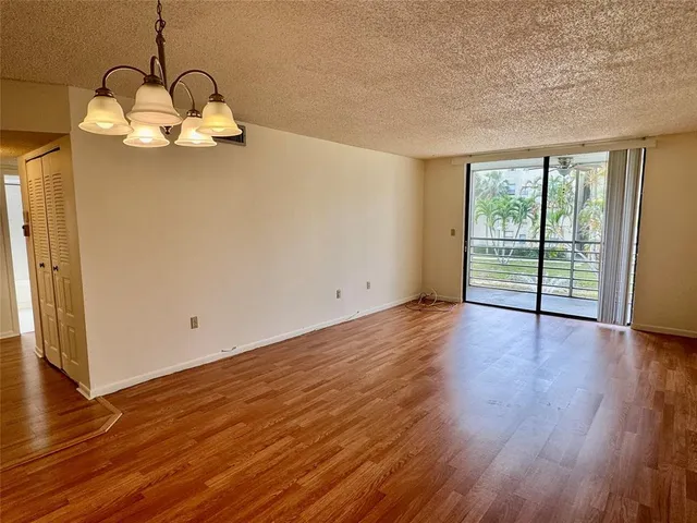 a view of a room with wooden floor and fan