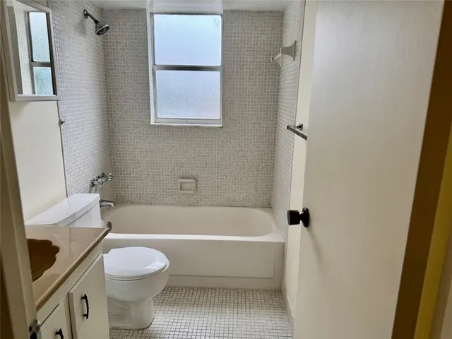 a view of a room with wooden floor and a window