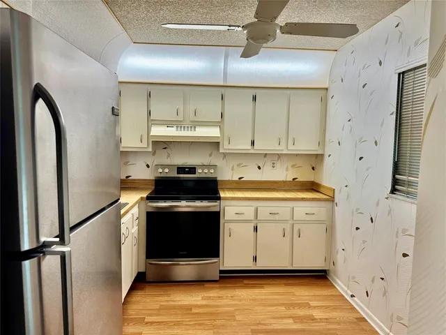 a kitchen with a sink a stove and refrigerator