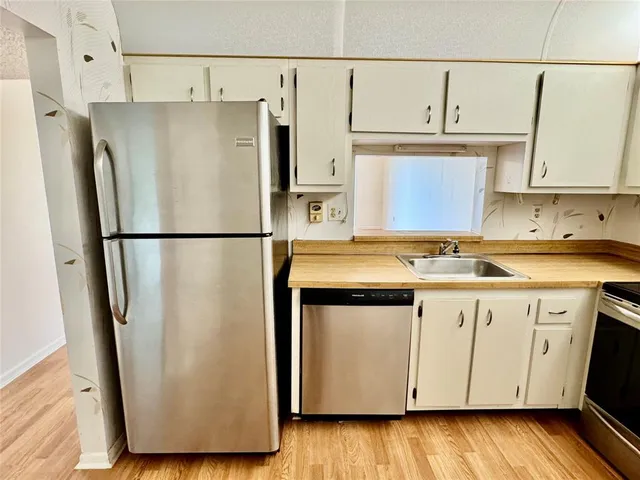 a kitchen with a sink stove and cabinets