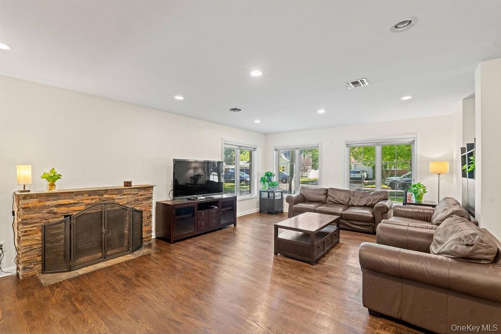 60 Plymouth Road Great Neck, NY 11023 - Photo 18 of 36 Living room featuring recessed lighting, wood finished floors, and a fireplace