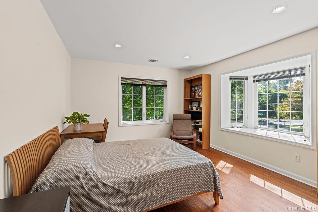 60 Plymouth Road Great Neck, NY 11023 - Photo 21 of 36 Bedroom featuring wood finished floors and recessed lighting