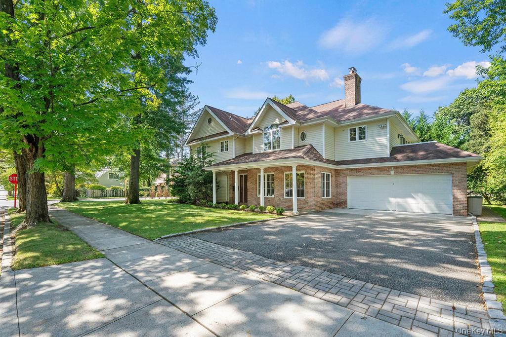 60 Plymouth Road Great Neck, NY 11023 - Photo 3 of 36 View of front of home with covered porch, a chimney, brick siding, and driveway
