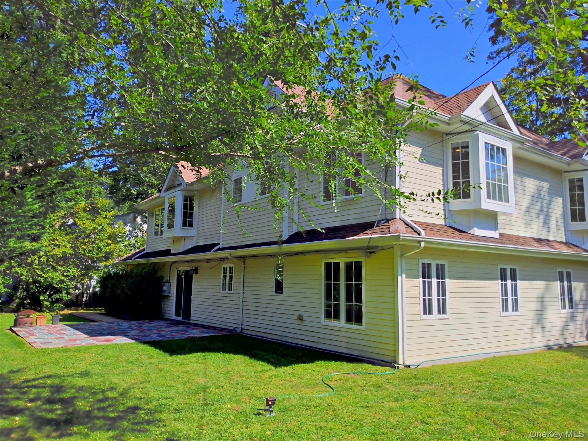 60 Plymouth Road Great Neck, NY 11023 - Photo 5 of 36 Rear view of property featuring a patio area and a yard