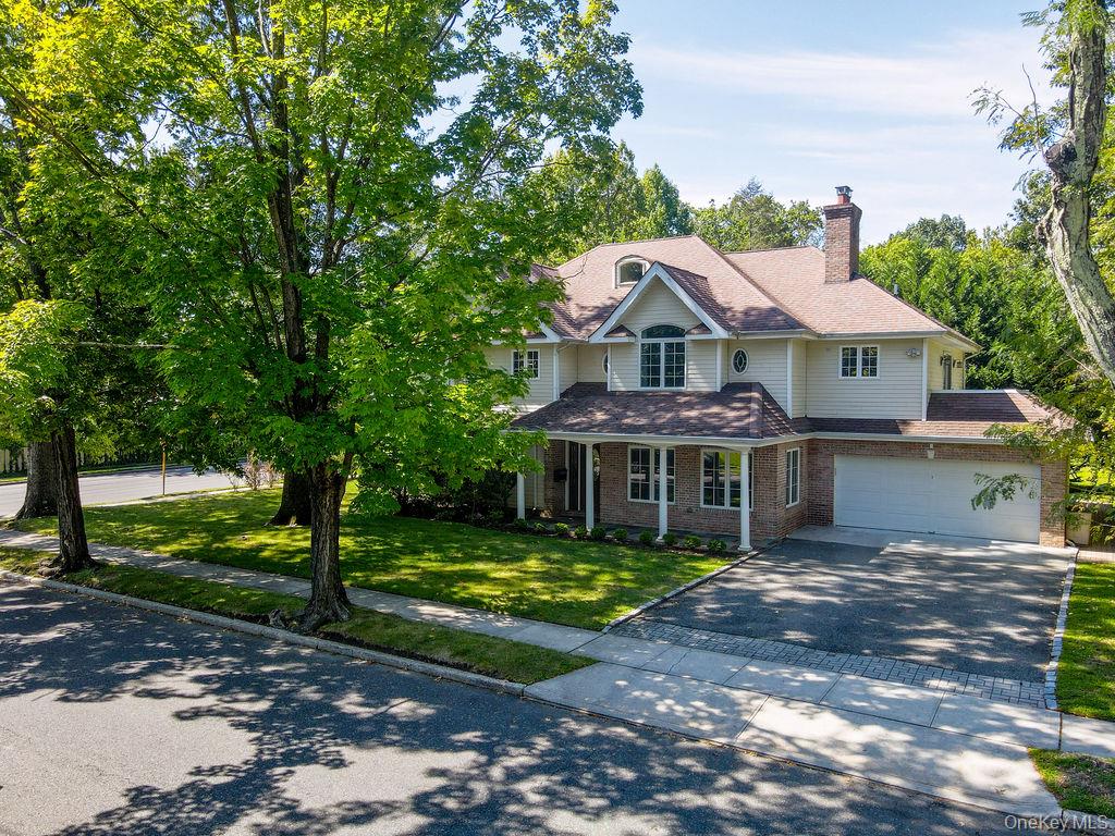 60 Plymouth Road Great Neck, NY 11023 - Photo 6 of 36 View of front of property featuring a porch, a chimney, driveway, a front lawn, and a shingled roof