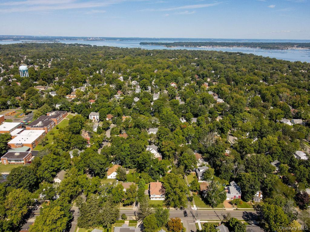 60 Plymouth Road Great Neck, NY 11023 - Photo 8 of 36 Drone / aerial view of a nearby body of water and a heavily wooded area