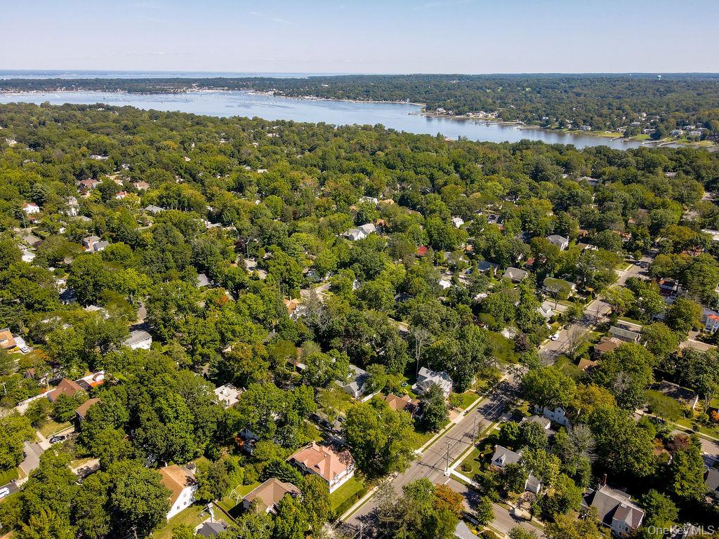 60 Plymouth Road Great Neck, NY 11023 - Photo 10 of 36 Drone / aerial view of a nearby body of water and a heavily wooded area