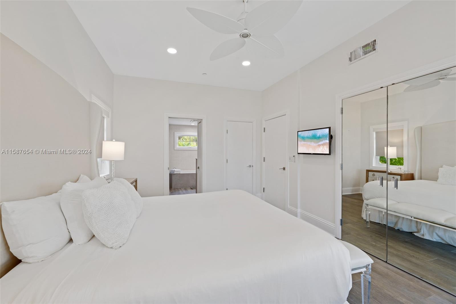 15122 Fisher Island Drive, Unit 15122 Miami Beach, FL 33109 - Photo 11 of 55 a bedroom with a bed and a lamp