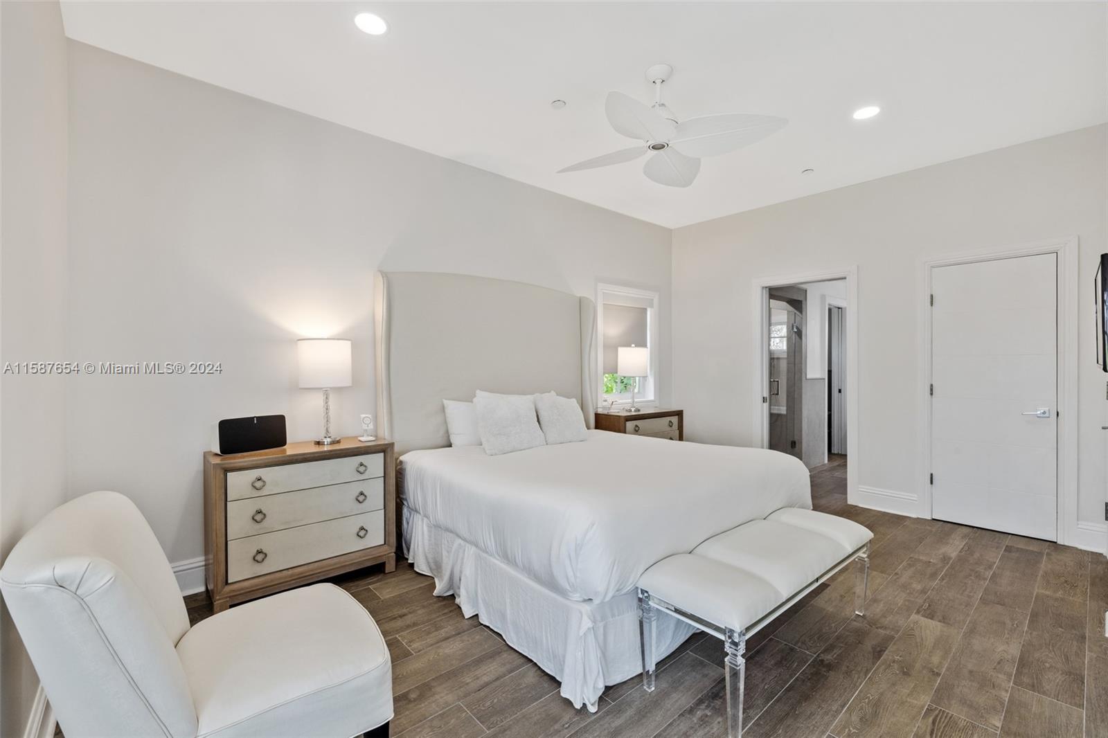 15122 Fisher Island Drive, Unit 15122 Miami Beach, FL 33109 - Photo 13 of 55 a bedroom with a bed and a chair