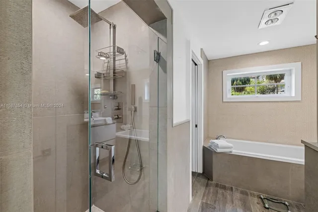 a bathroom with a bathtub and a shower