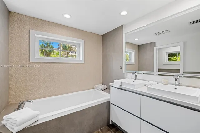 a spacious bathroom with a bathtub and a sink