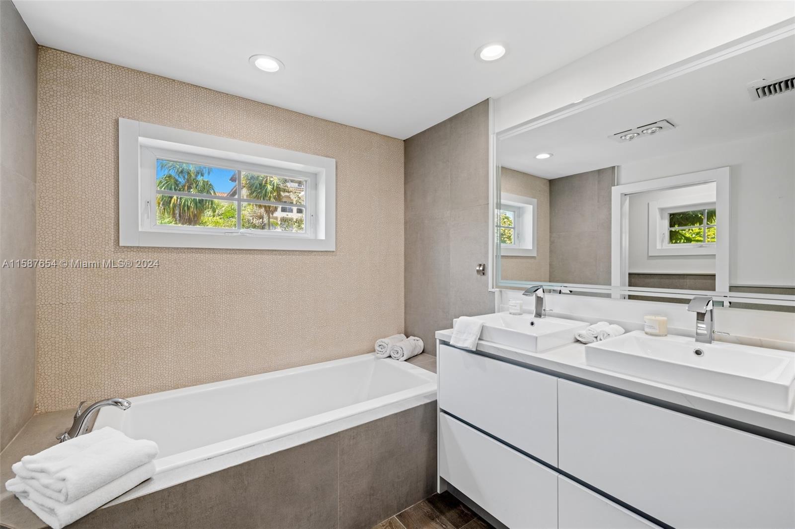 15122 Fisher Island Drive, Unit 15122 Miami Beach, FL 33109 - Photo 16 of 55 a spacious bathroom with a bathtub and a sink
