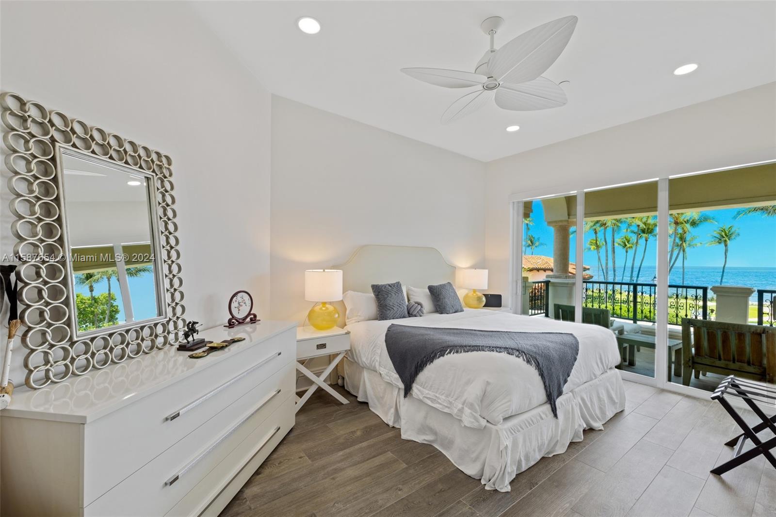 15122 Fisher Island Drive, Unit 15122 Miami Beach, FL 33109 - Photo 17 of 55 a bedroom with a bed a large window with table and chairs