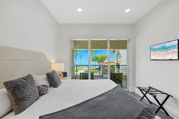 a bedroom with a bed and glass window