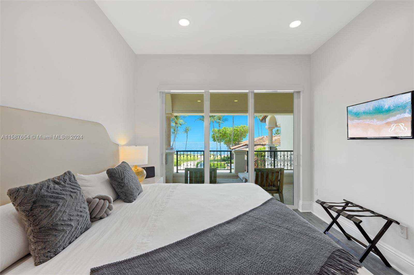 15122 Fisher Island Drive, Unit 15122 Miami Beach, FL 33109 - Photo 18 of 55 a bedroom with a bed and glass window