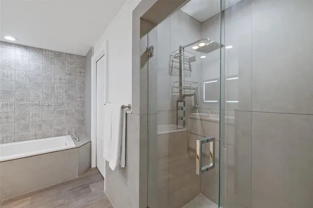 a bathroom with a shower and a bath tub