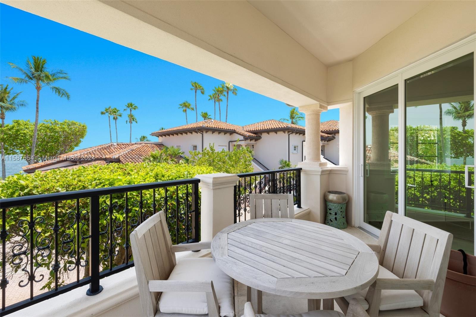 15122 Fisher Island Drive, Unit 15122 Miami Beach, FL 33109 - Photo 27 of 55 a view of a chairs and table in patio