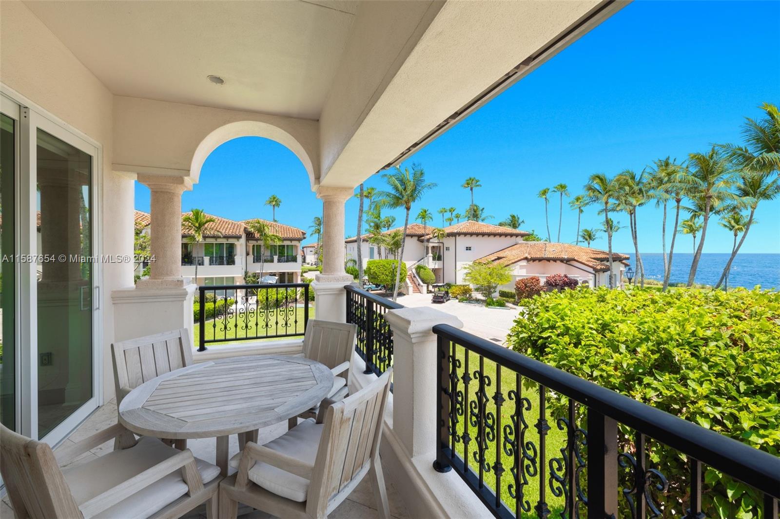 15122 Fisher Island Drive, Unit 15122 Miami Beach, FL 33109 - Photo 3 of 55 a view of a balcony with furniture and a potted plant