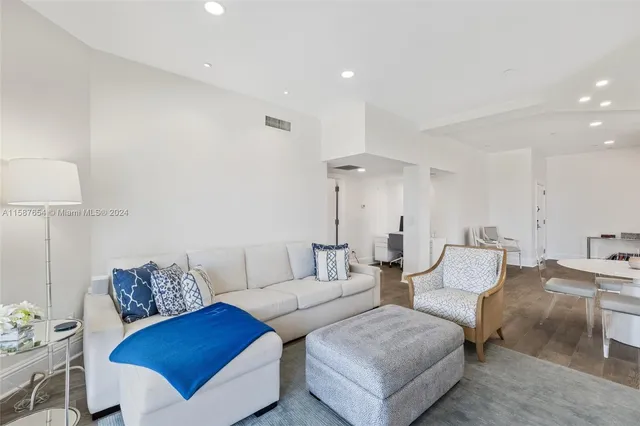 a living room with furniture and a lamp