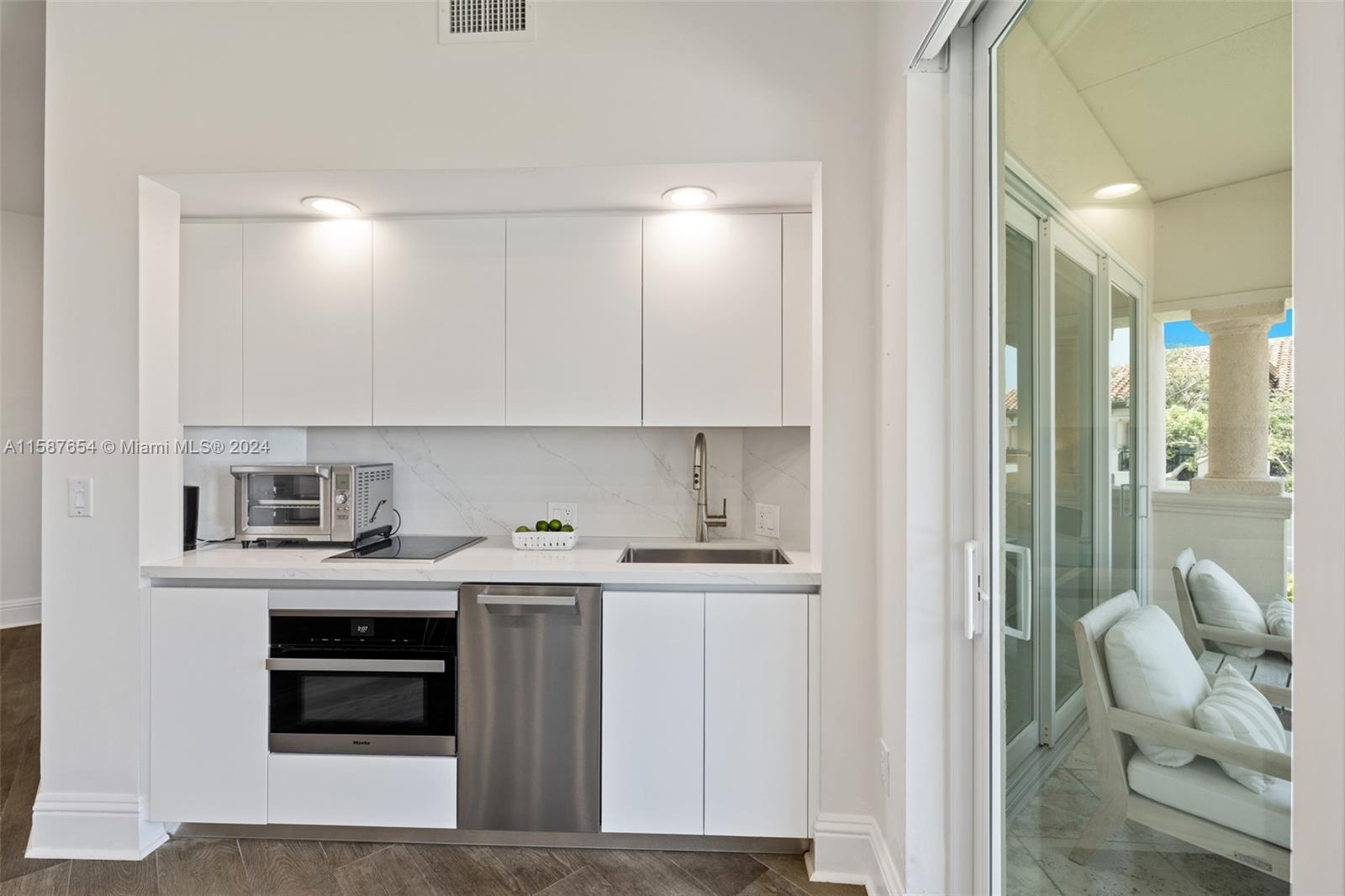15122 Fisher Island Drive, Unit 15122 Miami Beach, FL 33109 - Photo 10 of 55 a view of cabinets a sink and a stove top oven