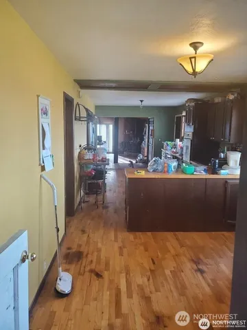 a living room with furniture and a dining table with kitchen view