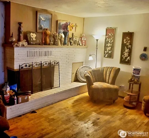 a living room with furniture gym equipment and a flat screen tv