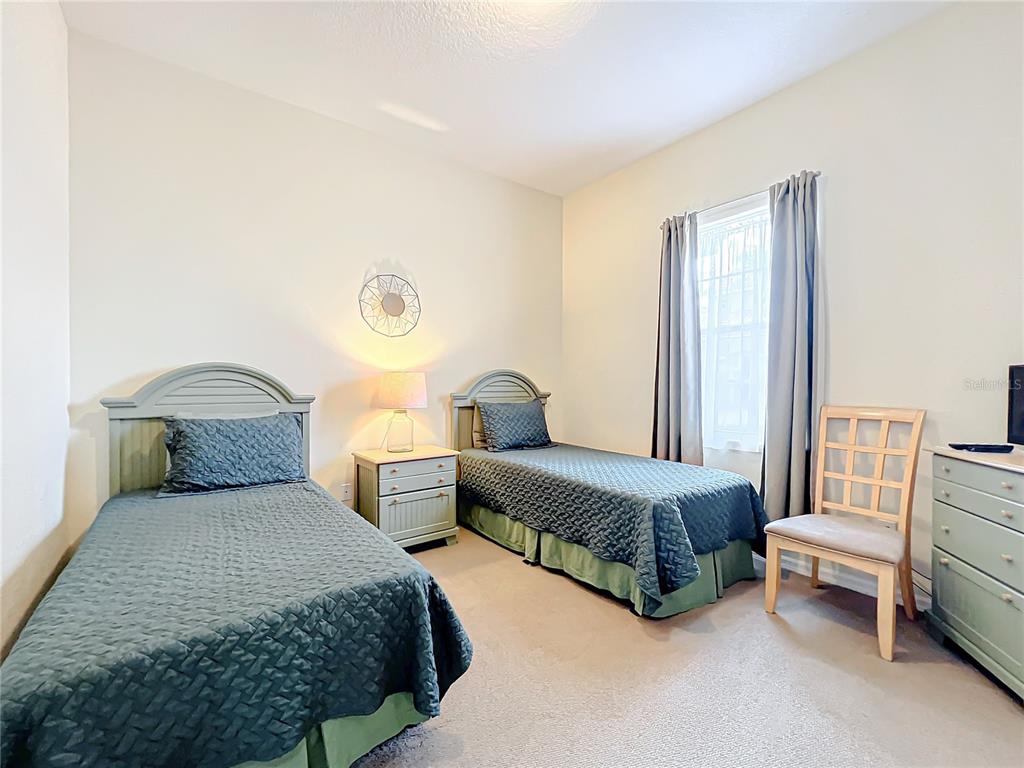 802 Brunello Drive Davenport, FL 33897 - Photo 15 of 36 a spacious bedroom with a bed and a window