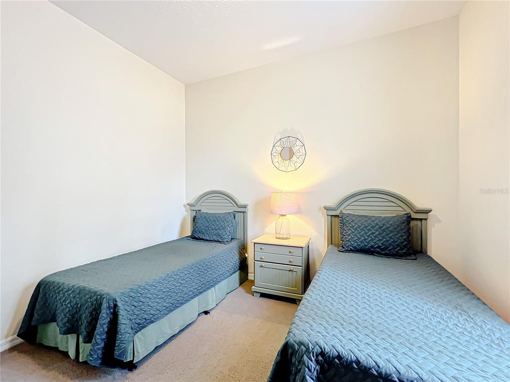 802 Brunello Drive Davenport, FL 33897 - Photo 16 of 36 a bedroom with a bed and a window