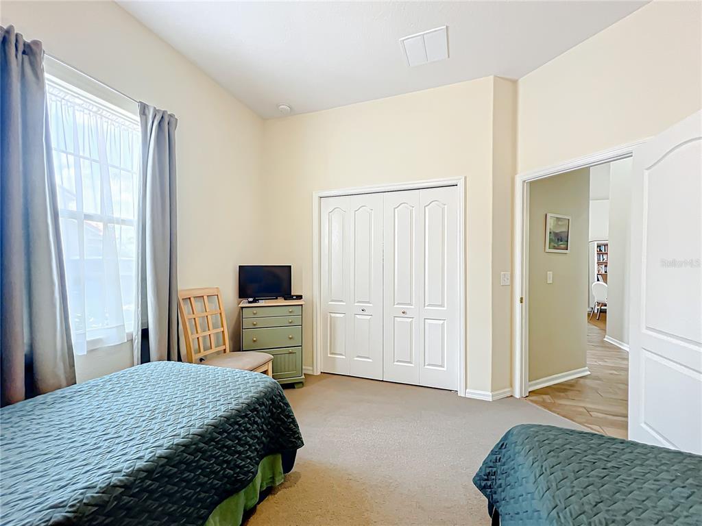 802 Brunello Drive Davenport, FL 33897 - Photo 17 of 36 a bedroom with a bed and a couch