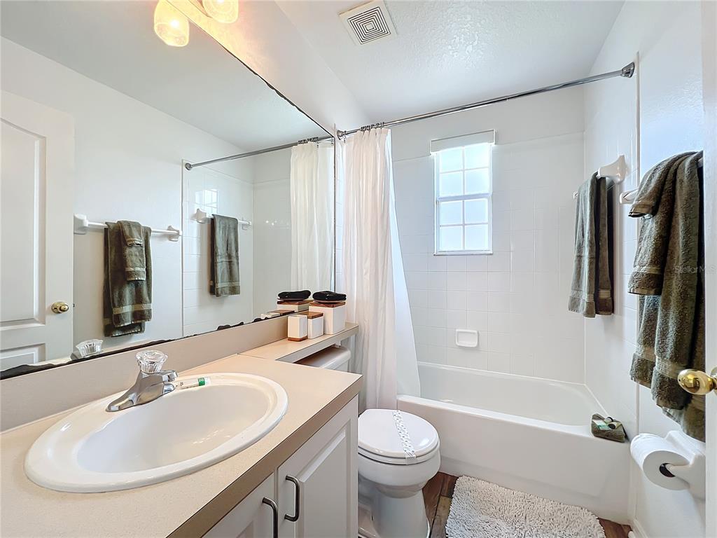 802 Brunello Drive Davenport, FL 33897 - Photo 20 of 36 a bathroom with a sink a toilet and shower