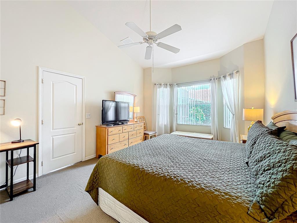 802 Brunello Drive Davenport, FL 33897 - Photo 21 of 36 a bedroom with a large bed and a window